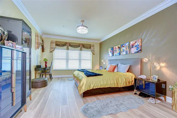 a bedroom with a bed and a large window