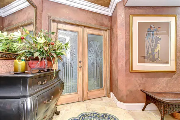 a view of a dining room with a table and chairs