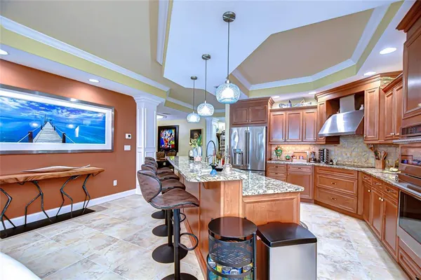 a large kitchen with cabinets table and chairs