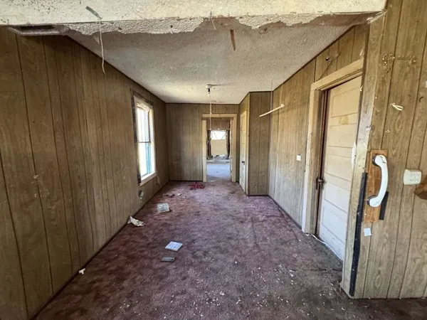 a view of a hallway with windows and entryway