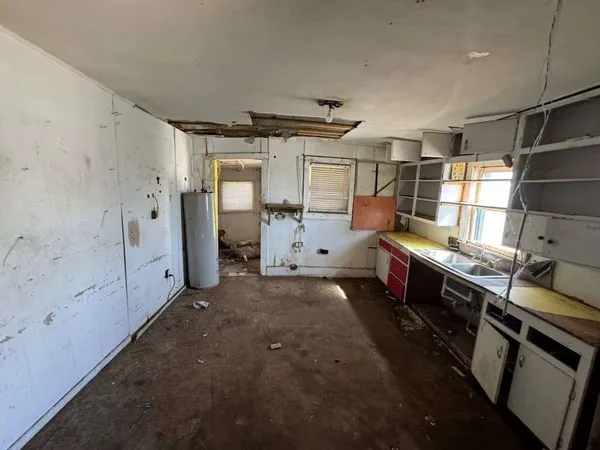 a kitchen with stainless steel appliances a stove refrigerator and cabinets