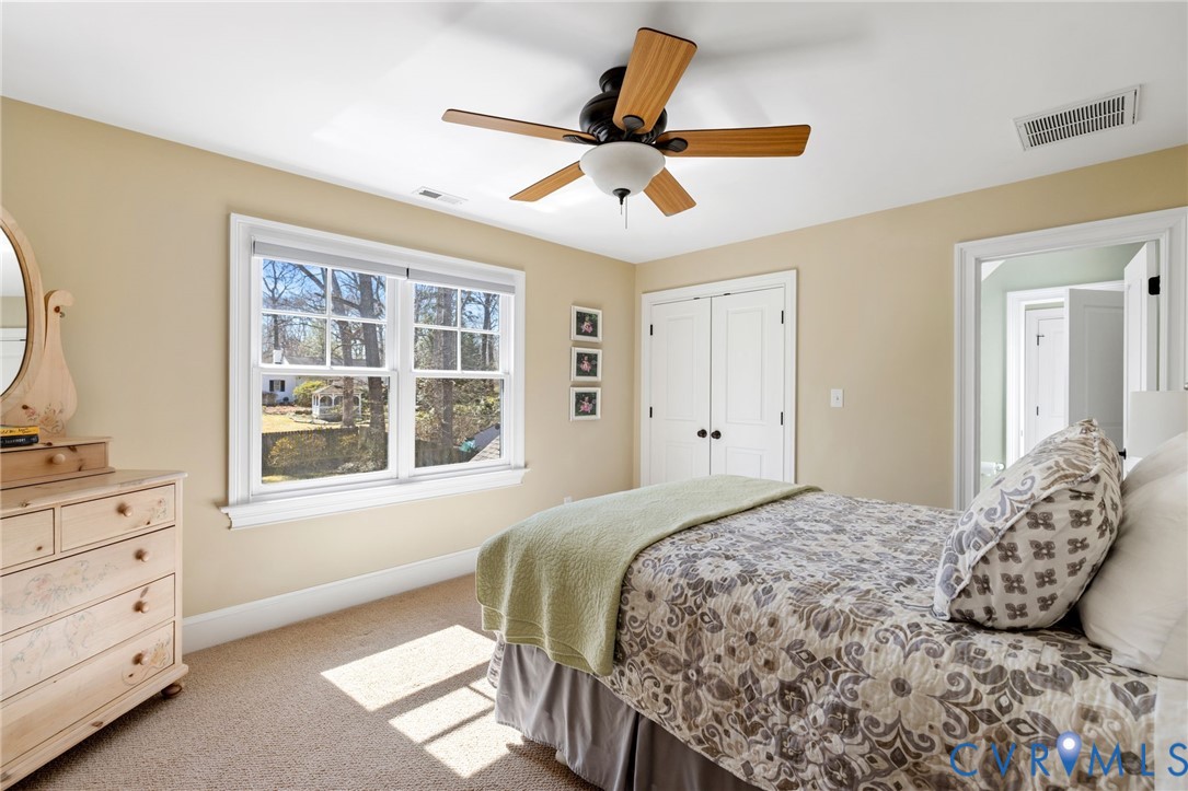 8947 Cherokee Road Richmond, VA 23235 - Photo 34 of 45 a bedroom with a large bed and a window