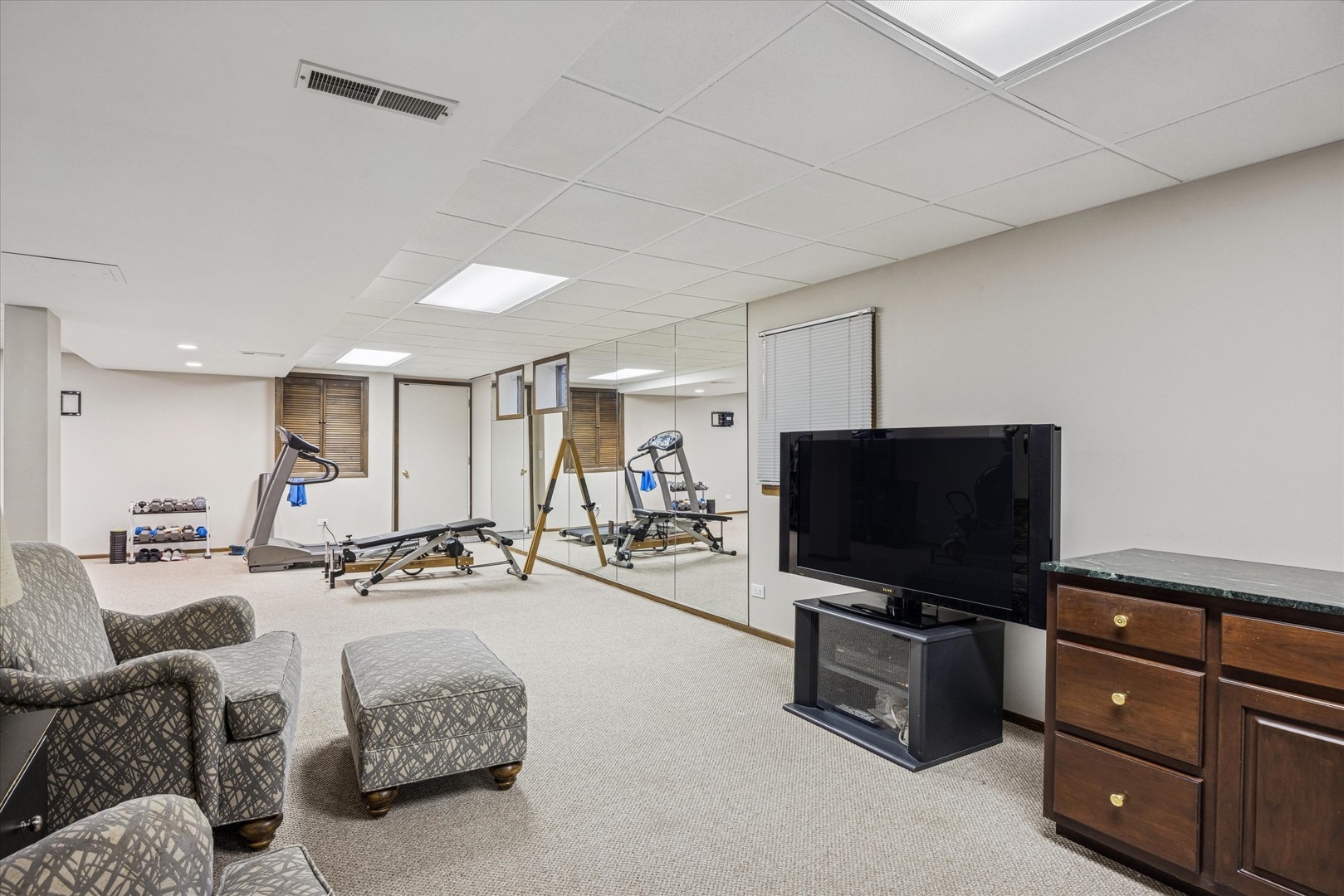 7612 Ridgewood Lane Burr Ridge, IL 60527 - Photo 18 of 36 a living room with furniture and a flat screen tv