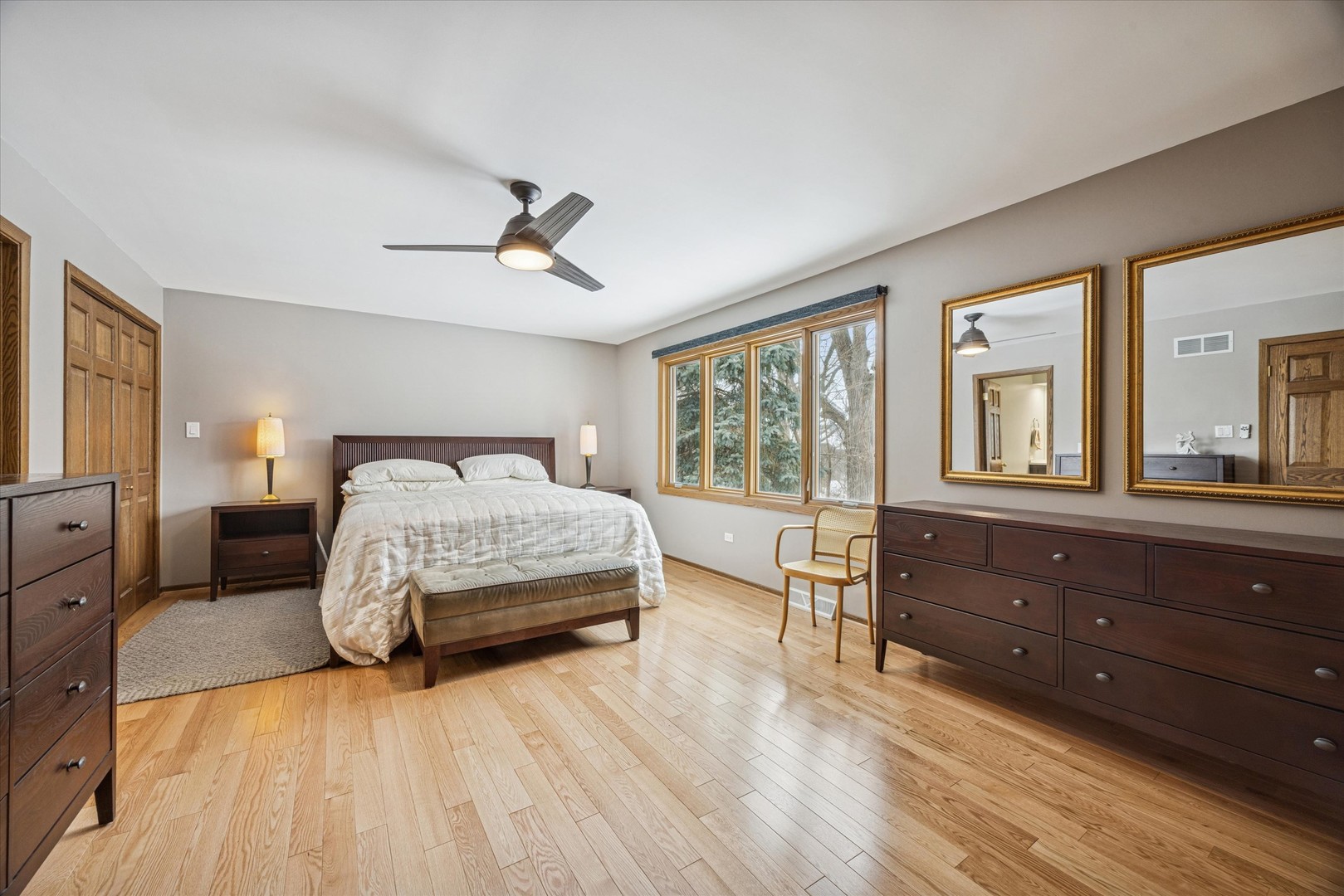 7612 Ridgewood Lane Burr Ridge, IL 60527 - Photo 10 of 36 a bedroom with a large bed and wooden floor