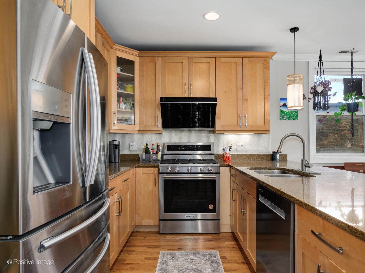 830 West Bradley Place, Unit 3S Chicago, IL 60613 - Photo 11 of 22 a kitchen with stainless steel appliances granite countertop a stove a sink and a microwave