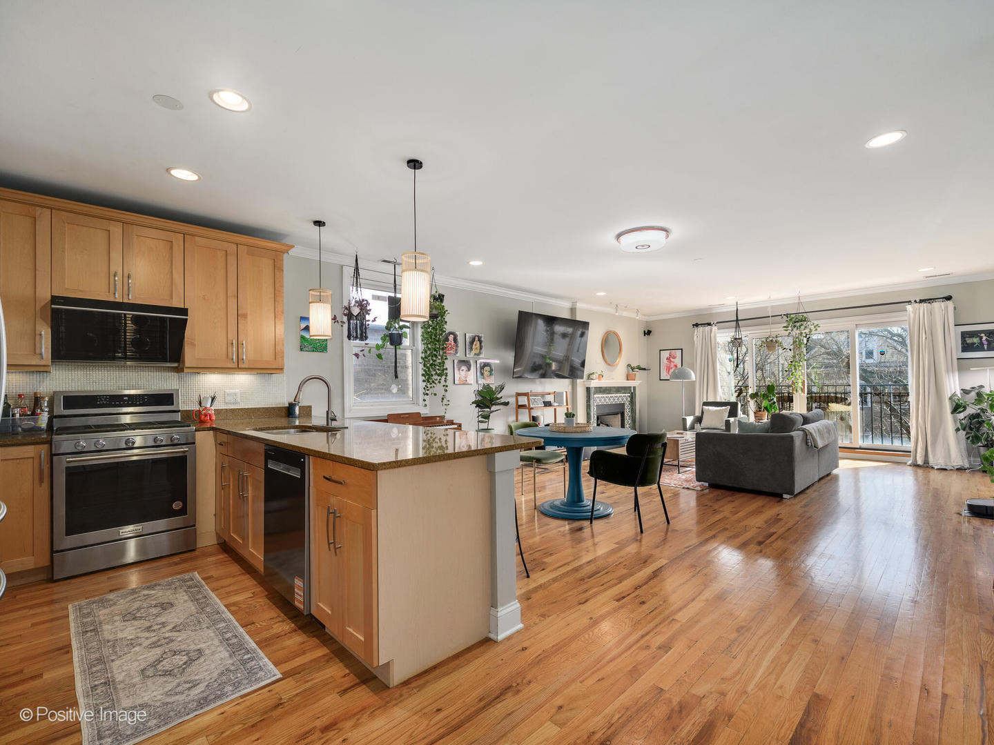 830 West Bradley Place, Unit 3S Chicago, IL 60613 - Photo 2 of 22 a kitchen with stainless steel appliances kitchen island granite countertop a stove top oven a sink dishwasher a dining table and chairs with wooden floor