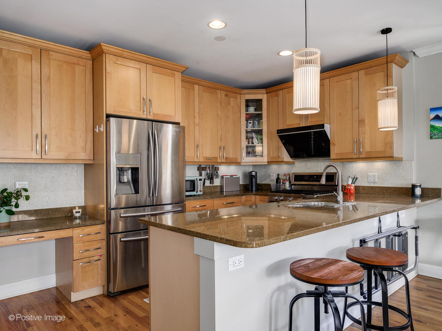 830 West Bradley Place, Unit 3S Chicago, IL 60613 - Photo 10 of 22 a kitchen with stainless steel appliances granite countertop a stove a refrigerator a oven a sink with a dining table and chairs
