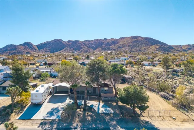 an aerial view of residential house and sandy dunes