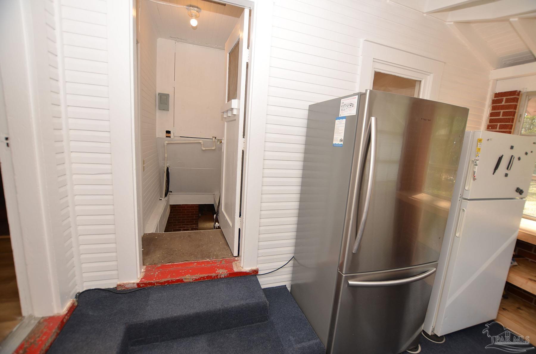 6475 Chestnut Road Molino, FL 32577 - Photo 16 of 67 a view of a refrigerator in kitchen and an empty room