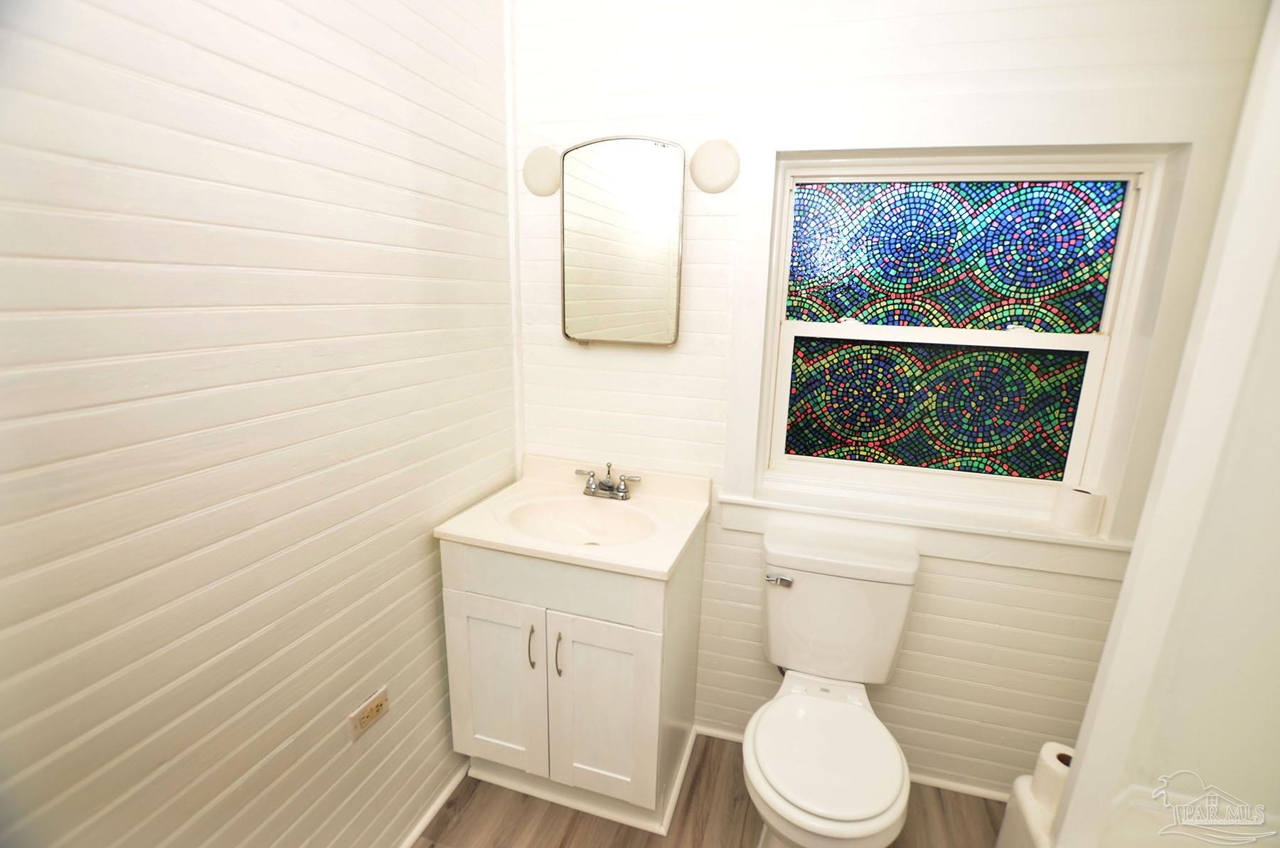 6475 Chestnut Road Molino, FL 32577 - Photo 29 of 67 a bathroom with a toilet a sink a vanity and mirror