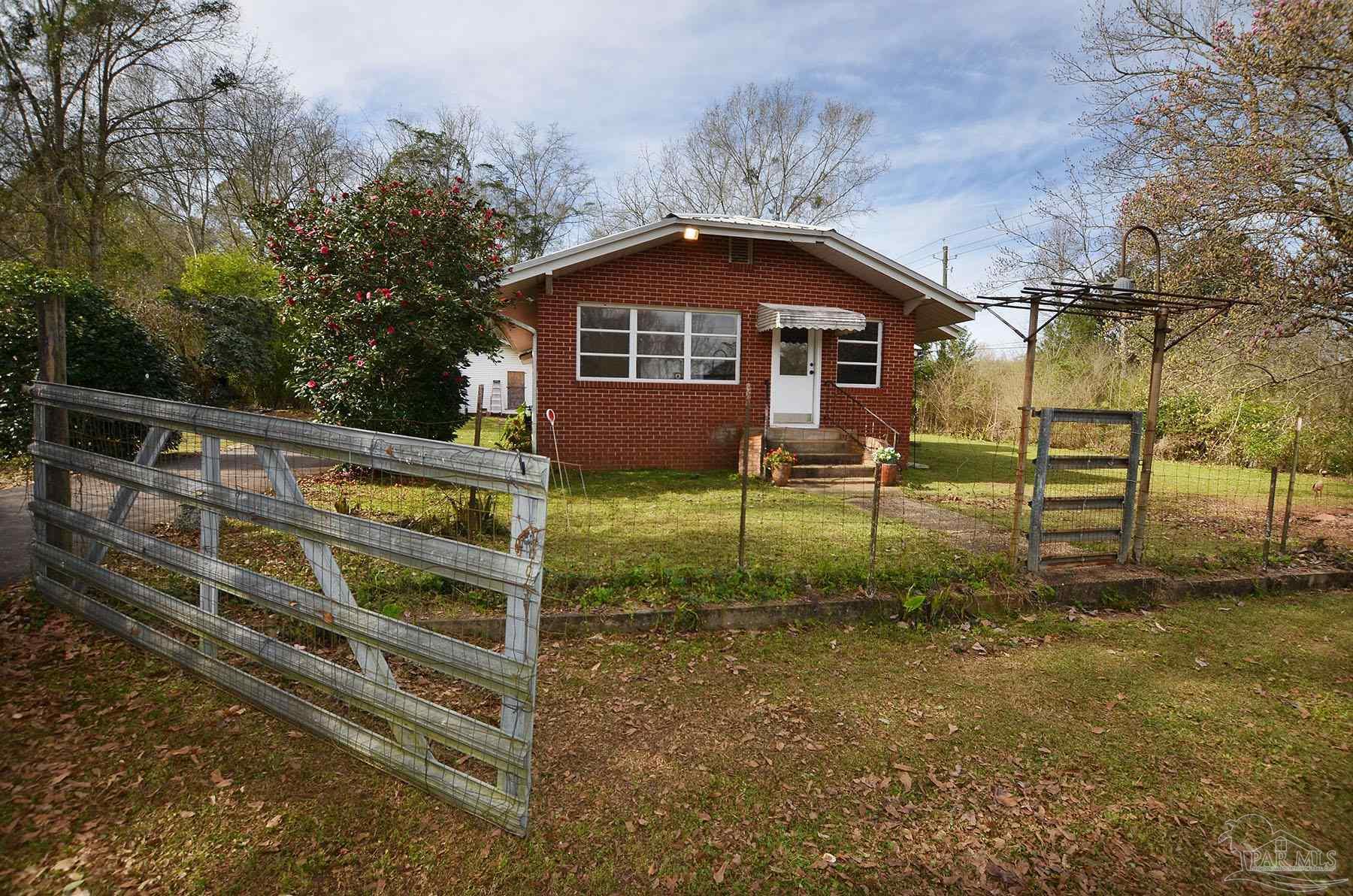 6475 Chestnut Road Molino, FL 32577 - Photo 50 of 67 a front view of a house with garden