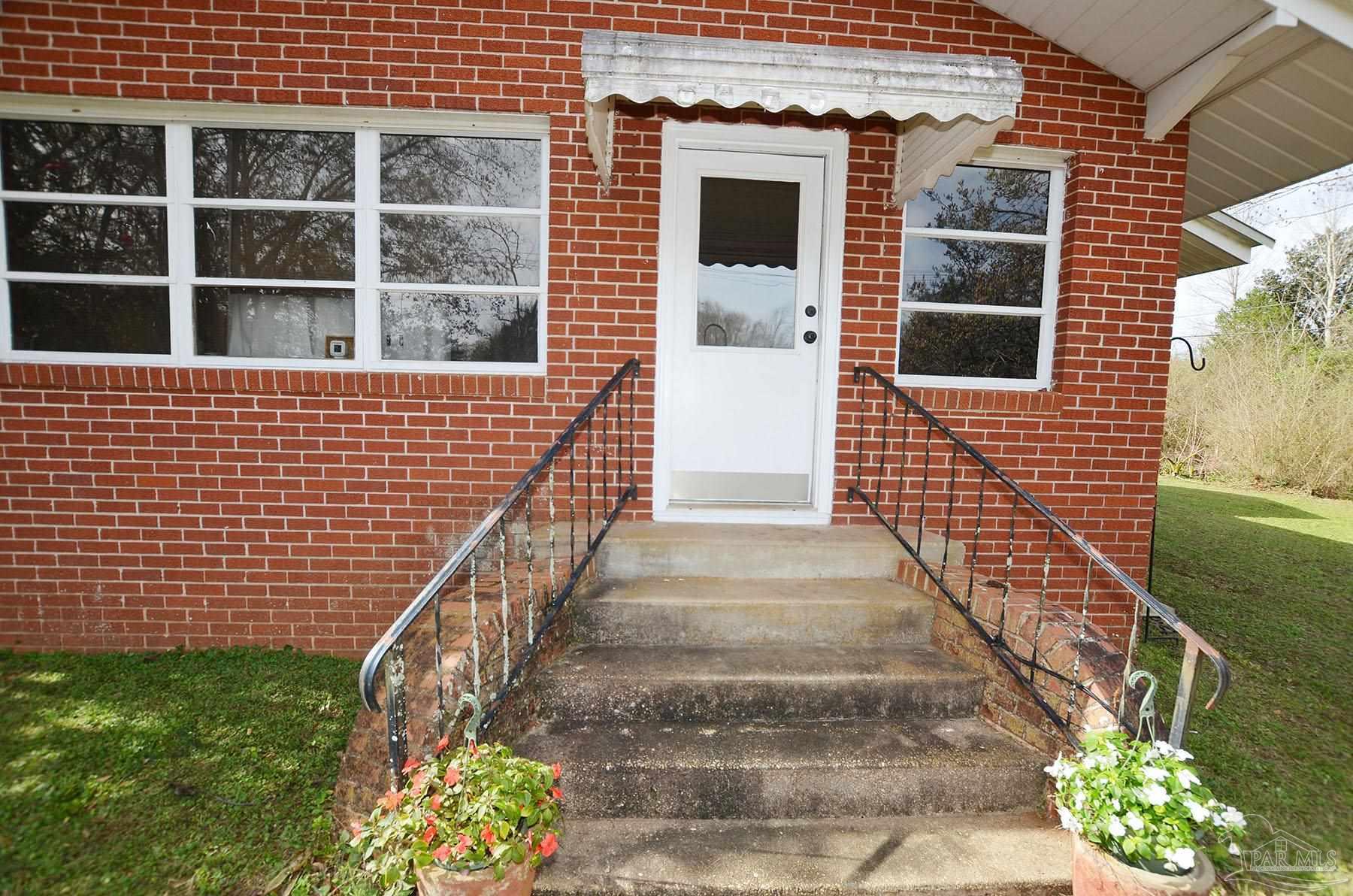 6475 Chestnut Road Molino, FL 32577 - Photo 5 of 67 a front view of a house with a yard