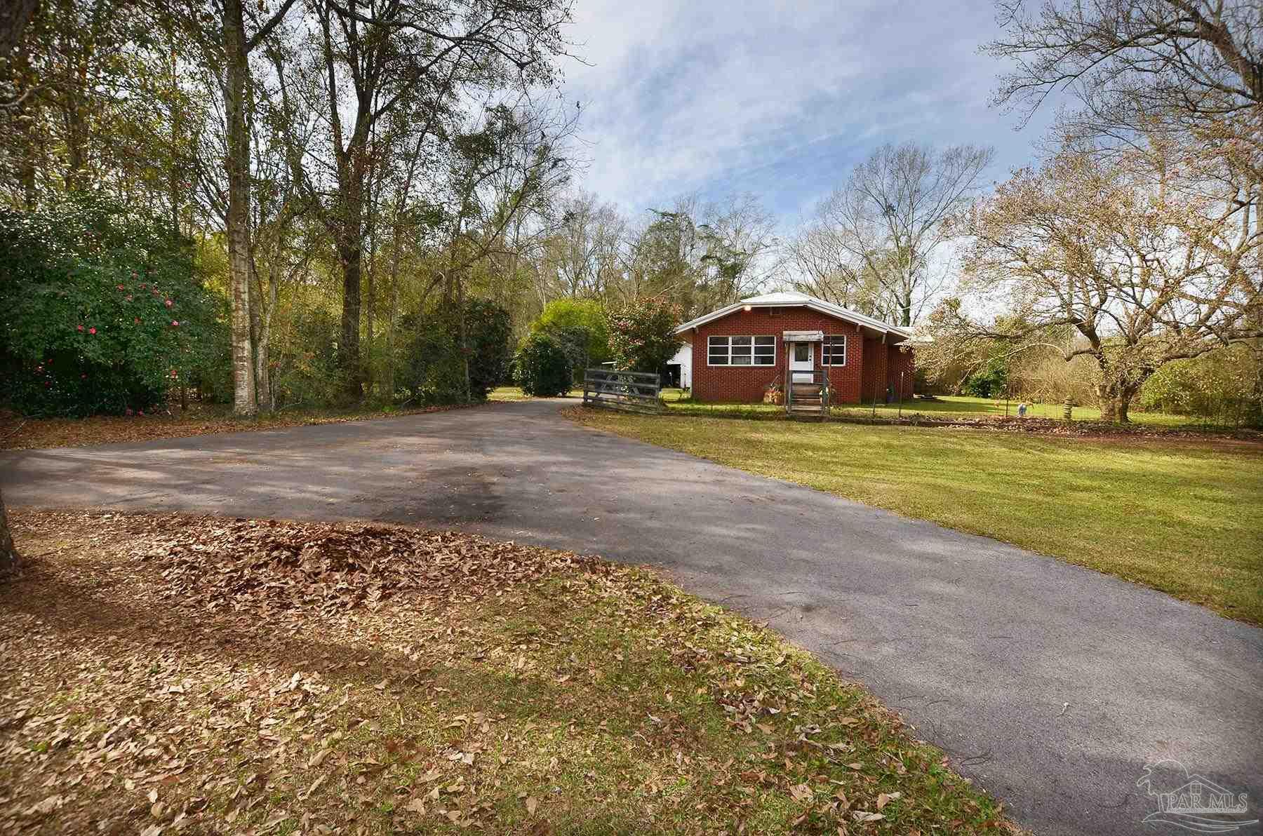 6475 Chestnut Road Molino, FL 32577 - Photo 56 of 67 a big house with a big yard and large trees