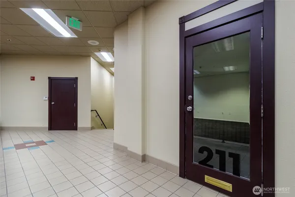 a view of pool with brick wall and a chair