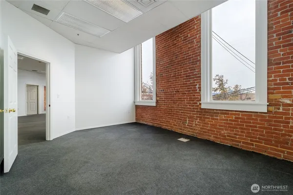 en empty room with windows and entrance