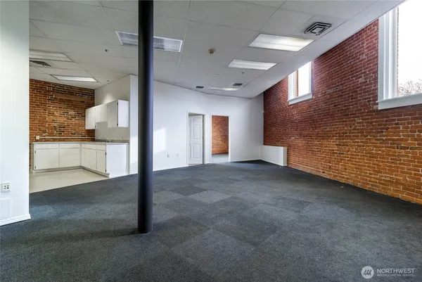 a view of a livingroom with an empty space and a window