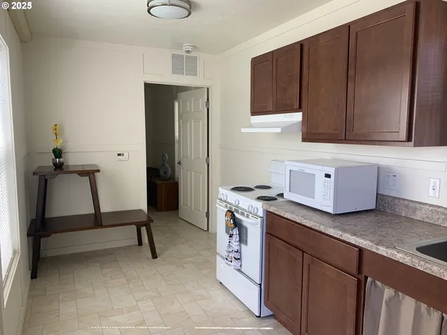 a kitchen with a sink cabinets and utility room