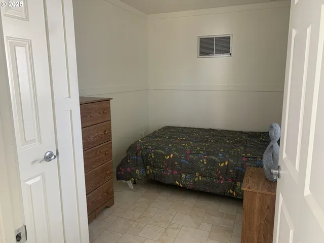 a bedroom with a bed and a cabinets