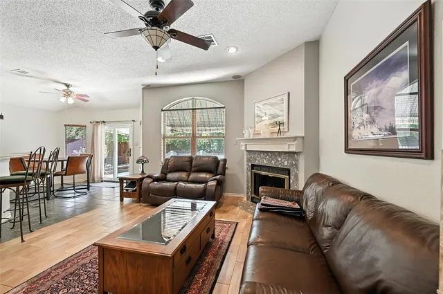 a living room with furniture a large window and a fireplace