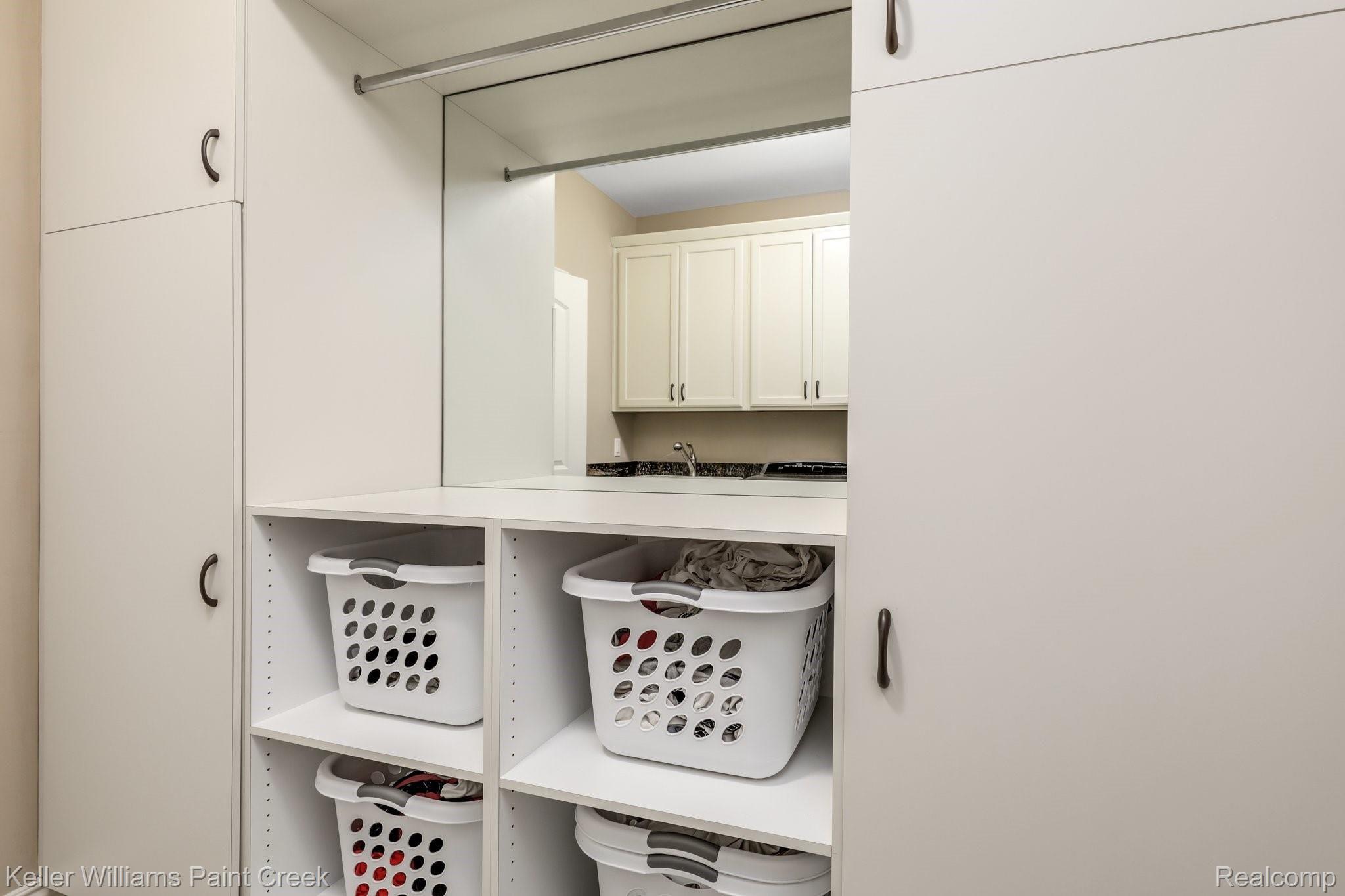 1027 Hampshire Court Rochester, MI 48307 - Photo 28 of 30 Custom shelving and storage unit in the laundry matches the master closet.