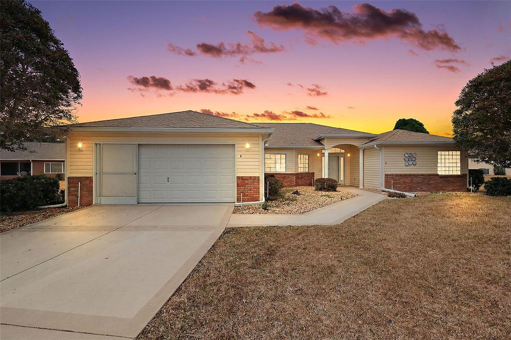 8739 Southeast 140th Place Road Summerfield, FL 34491 - Photo 1 of 45 a front view of a house with a garden and yard