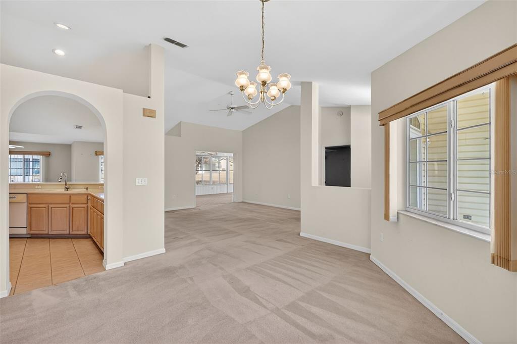 8739 Southeast 140th Place Road Summerfield, FL 34491 - Photo 15 of 45 a view of a livingroom with a ceiling fan window and wooden floor