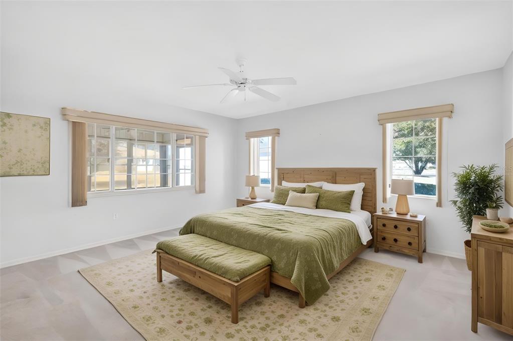 8739 Southeast 140th Place Road Summerfield, FL 34491 - Photo 22 of 45 a bedroom with a bed couch and windows