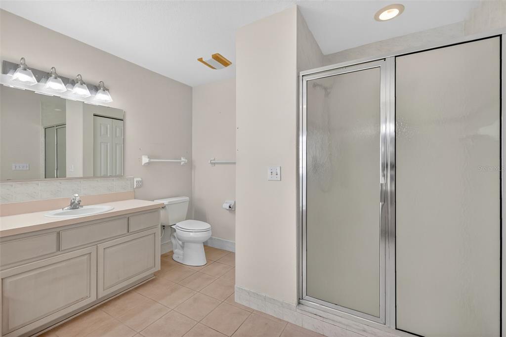8739 Southeast 140th Place Road Summerfield, FL 34491 - Photo 27 of 45 a bathroom with a double vanity sink mirror and toilet