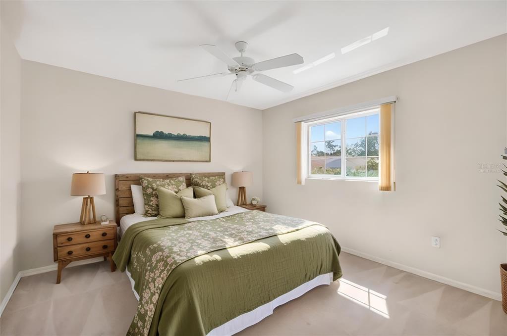8739 Southeast 140th Place Road Summerfield, FL 34491 - Photo 29 of 45 a bedroom with a bed and a painting on the wall