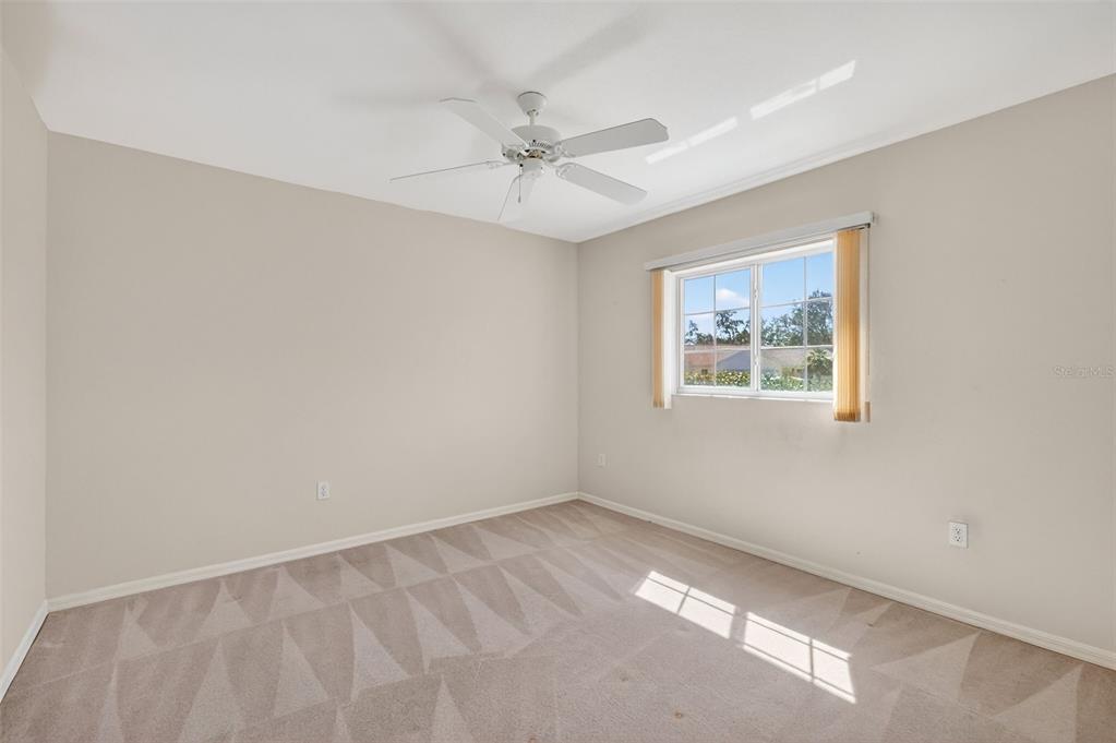 8739 Southeast 140th Place Road Summerfield, FL 34491 - Photo 30 of 45 an empty room with a window and a fan