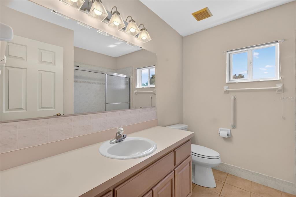 8739 Southeast 140th Place Road Summerfield, FL 34491 - Photo 32 of 45 a bathroom with a toilet sink and mirror