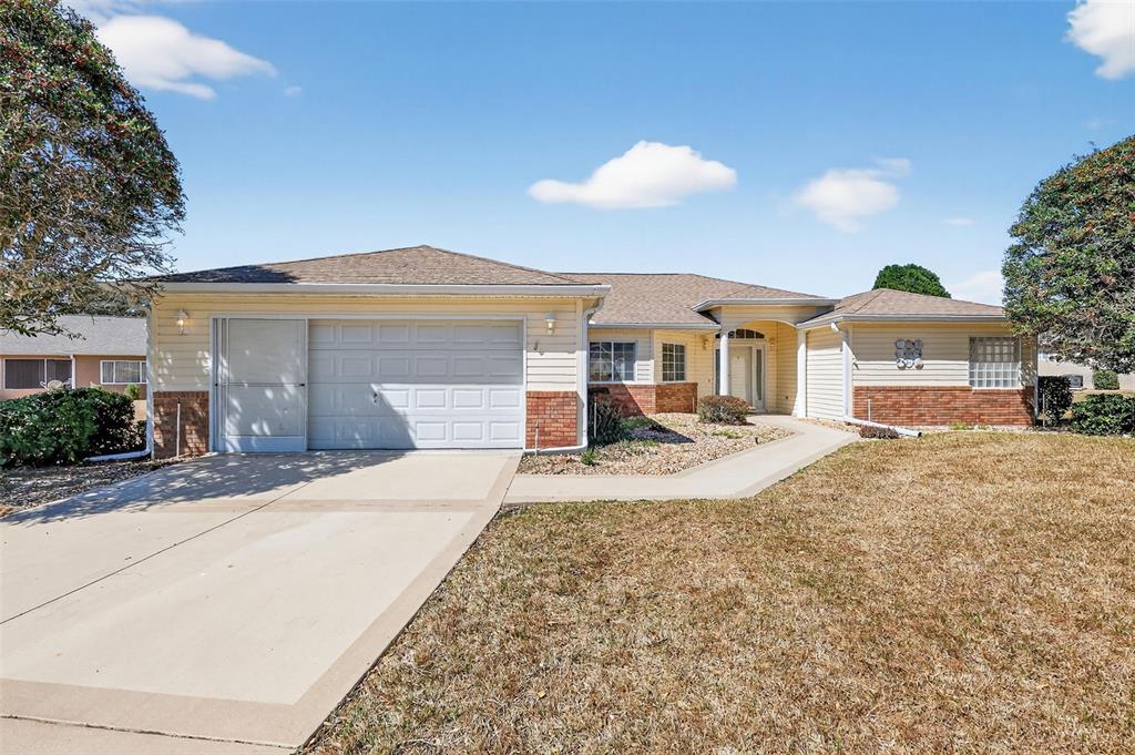 8739 Southeast 140th Place Road Summerfield, FL 34491 - Photo 41 of 45 a front view of a house with a yard and garage