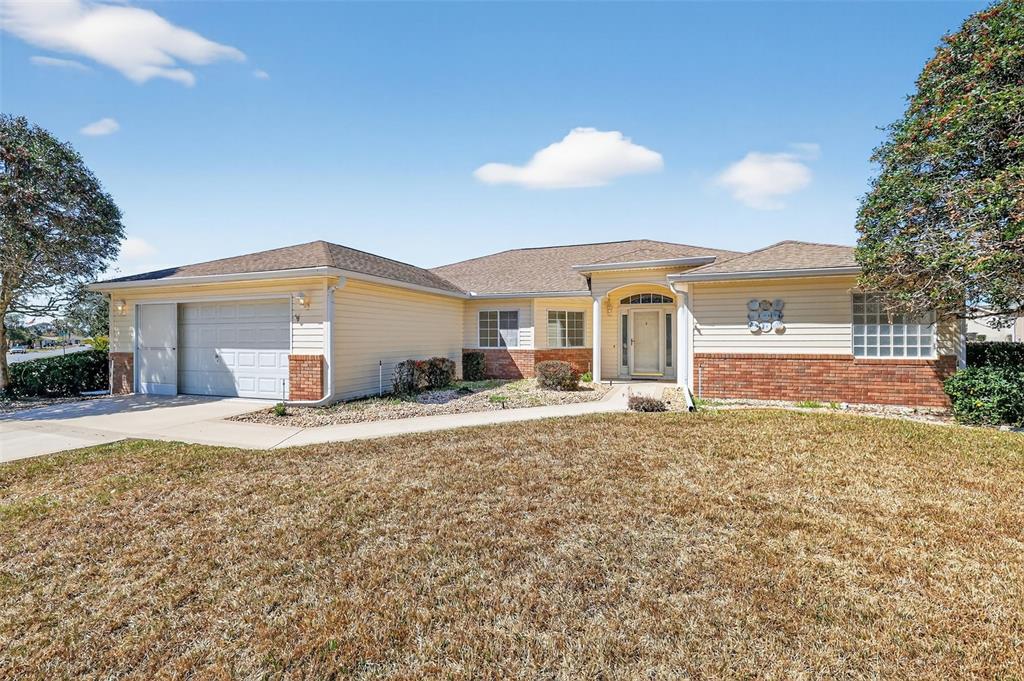 8739 Southeast 140th Place Road Summerfield, FL 34491 - Photo 42 of 45 a front view of a house with a yard and garage