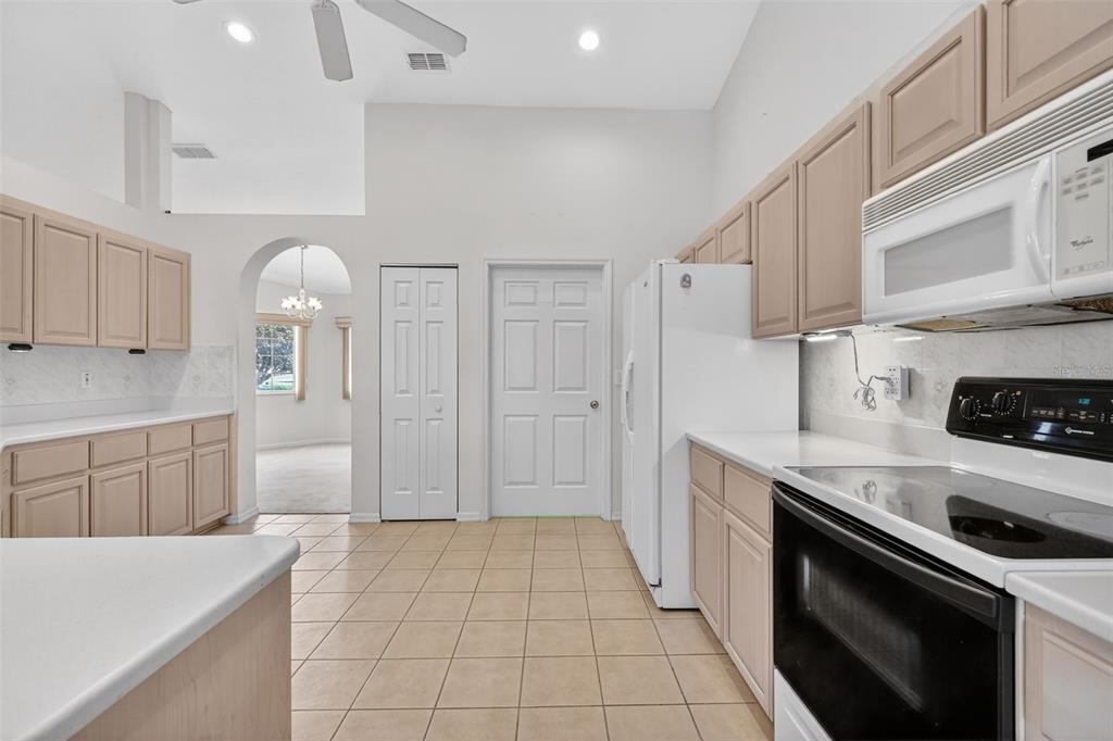8739 Southeast 140th Place Road Summerfield, FL 34491 - Photo 6 of 45 a kitchen with a sink stove and cabinets