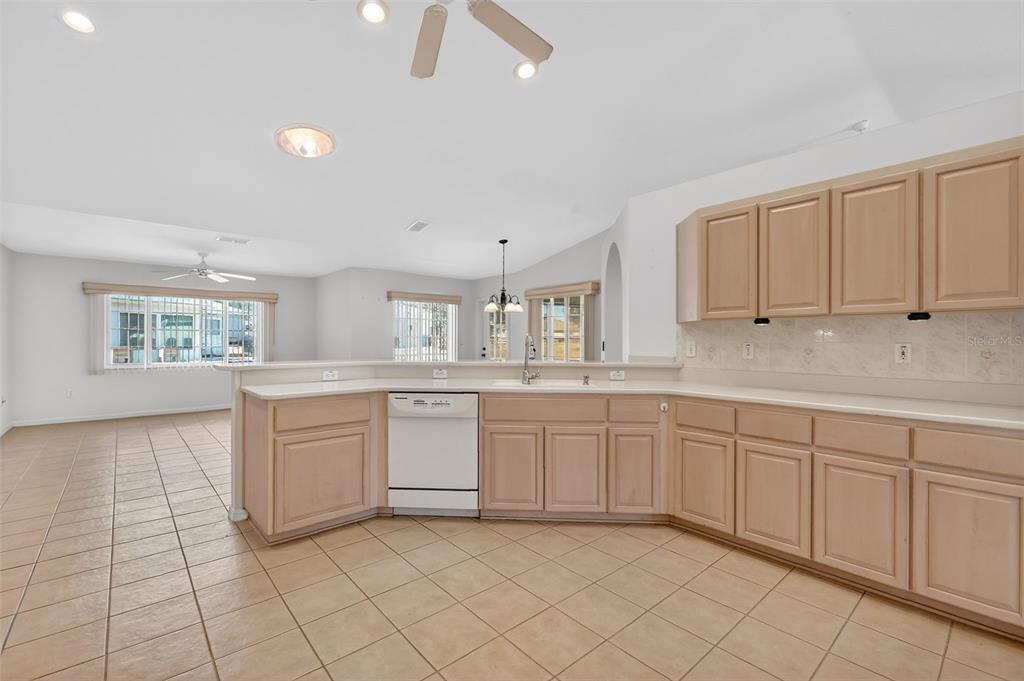 8739 Southeast 140th Place Road Summerfield, FL 34491 - Photo 7 of 45 a large white kitchen with a sink and cabinets