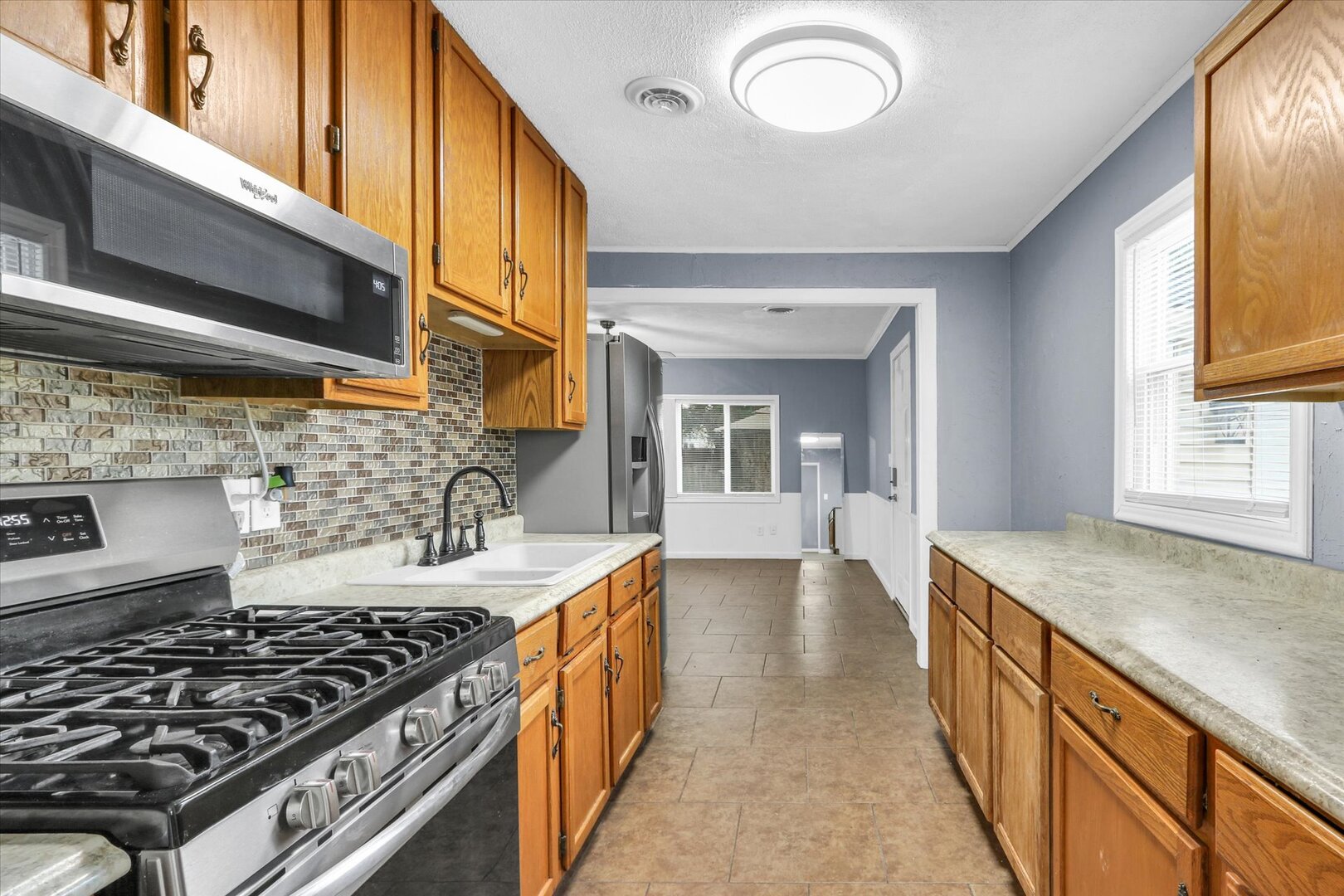 817 Roselyn Drive Rantoul, IL 61866 - Photo 11 of 33 a kitchen with sink stove and cabinets