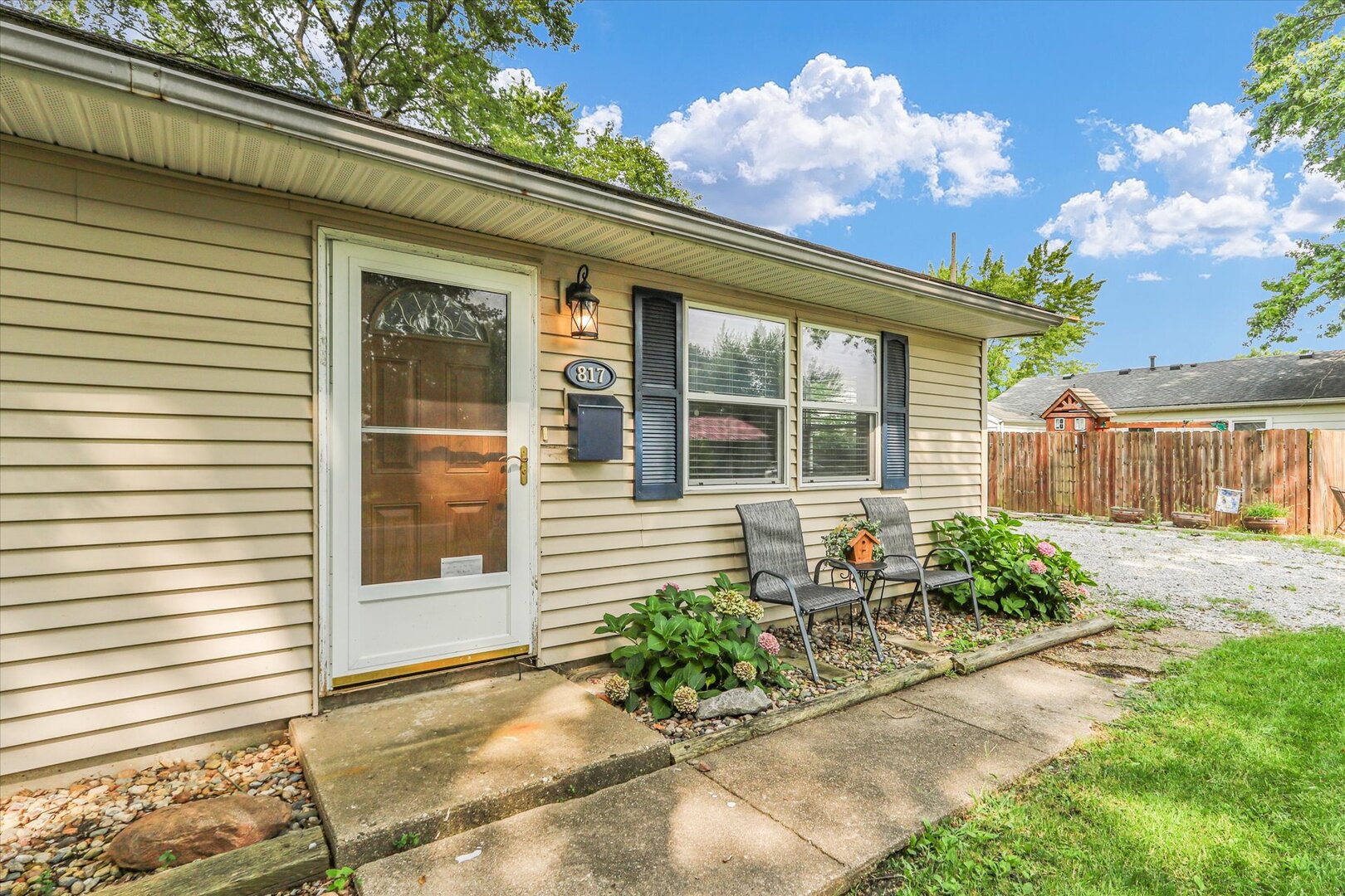 817 Roselyn Drive Rantoul, IL 61866 - Photo 3 of 33 a front view of a house with outdoor seating and a potted plant