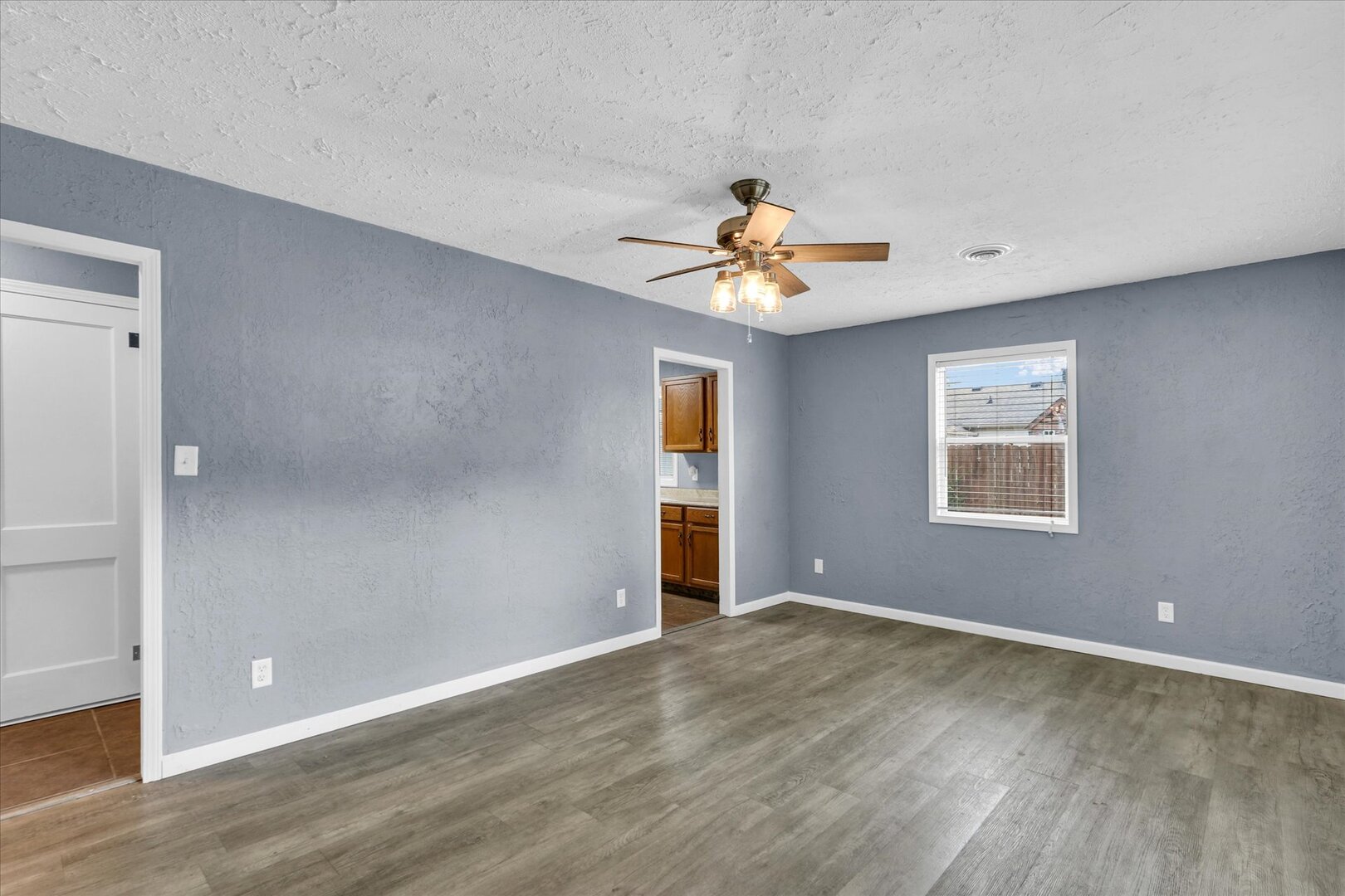 817 Roselyn Drive Rantoul, IL 61866 - Photo 4 of 33 wooden floor in an empty room with a window