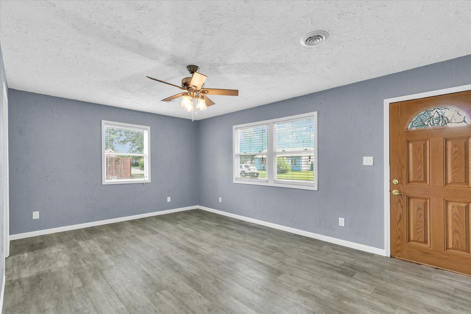 817 Roselyn Drive Rantoul, IL 61866 - Photo 5 of 33 wooden floor in an empty room with a window