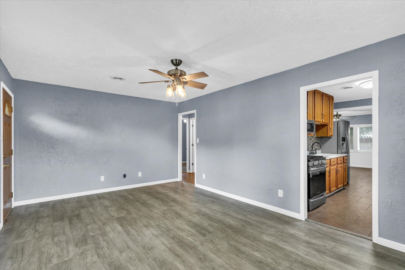 817 Roselyn Drive Rantoul, IL 61866 - Photo 7 of 33 wooden floor in an empty room with a chandelier