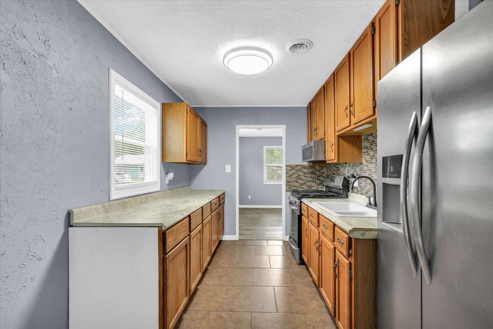 817 Roselyn Drive Rantoul, IL 61866 - Photo 8 of 33 a kitchen with stainless steel appliances granite countertop a refrigerator a stove and a sink