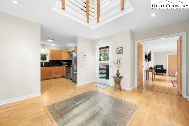 a large kitchen with stainless steel appliances lots of counter space and a sink