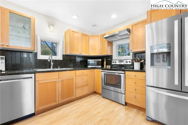 a view of a livingroom with wooden floor and furniture