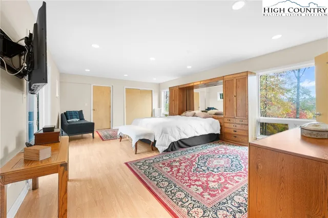 a bed room with a bed and glass walk in closet