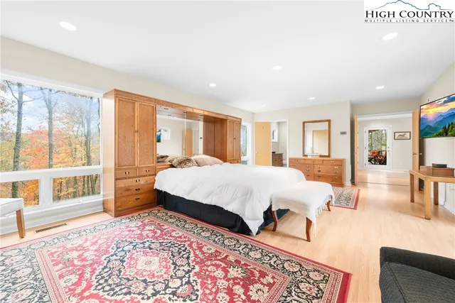 a bedroom with a bed and glass door