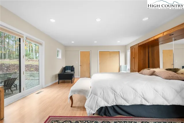 a bathroom with a granite countertop sink a mirror and a shower