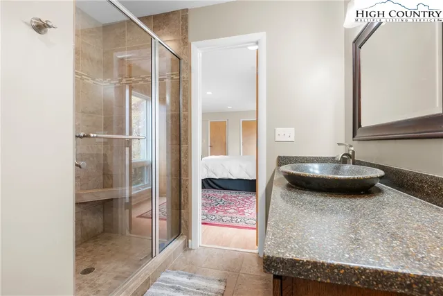 a bedroom with furniture and a flat screen tv