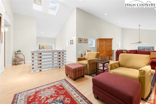 a spacious bedroom with a large bed and a chandelier