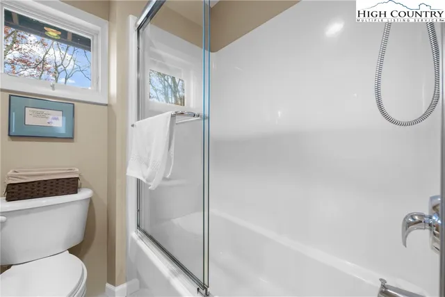 a room with a bed and a large window