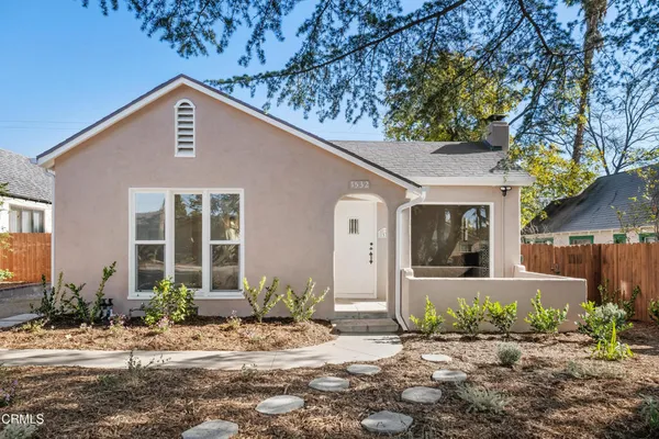 a front view of a house with garden